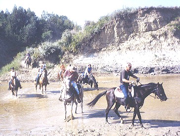 DJ in front water crossing Badlands
